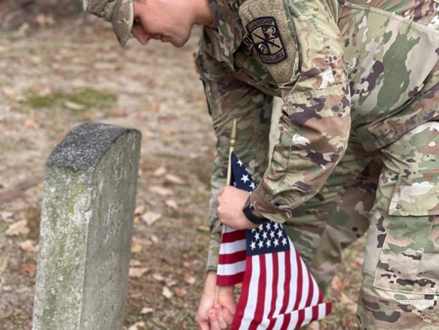 Soldier placing flag