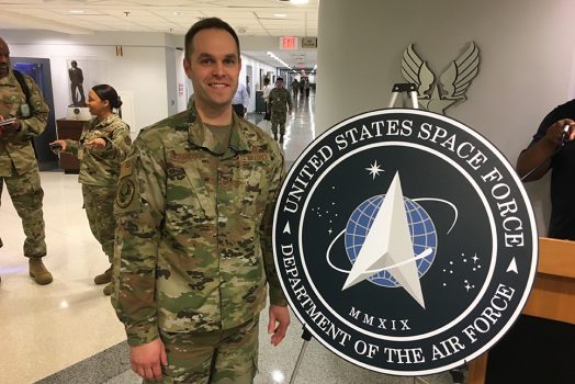 Man stands near sign