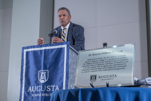 man speaks at podium