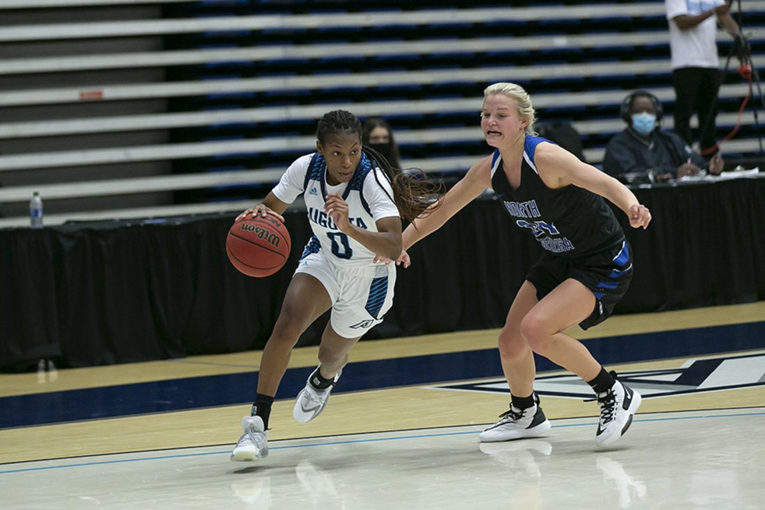 Two women playing basketball