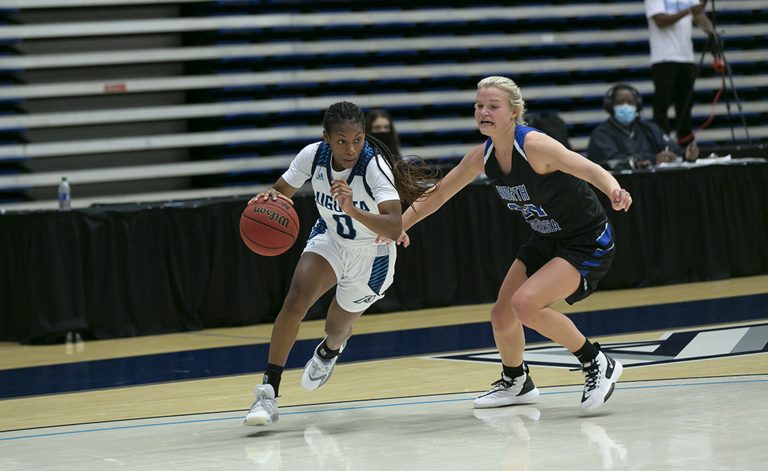 Two women playing basketball