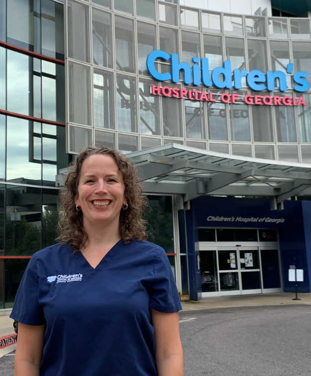 woman smiling in front of Children's Hospital of Georgia