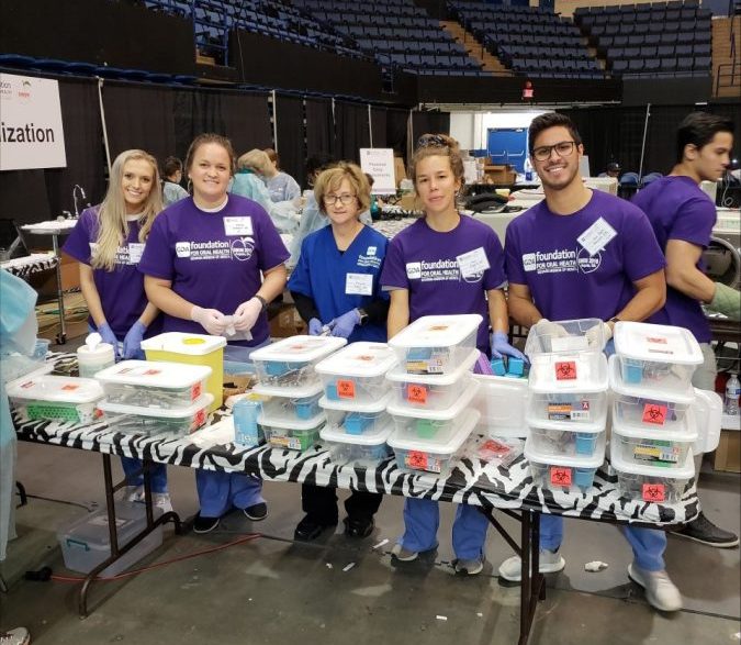 group of dental students volunteering at a table
