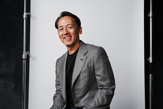 man in grey suit smiling