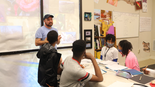 man teaching students