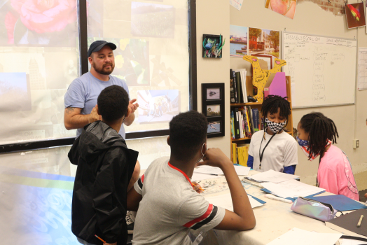 man teaching students
