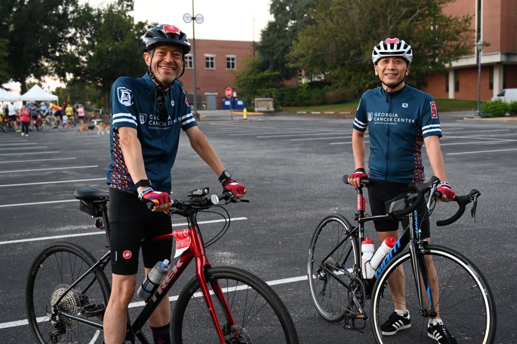 Two people standing with bicycles