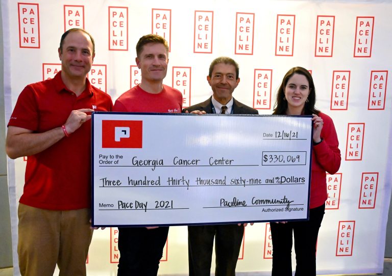 People standing hold a big check
