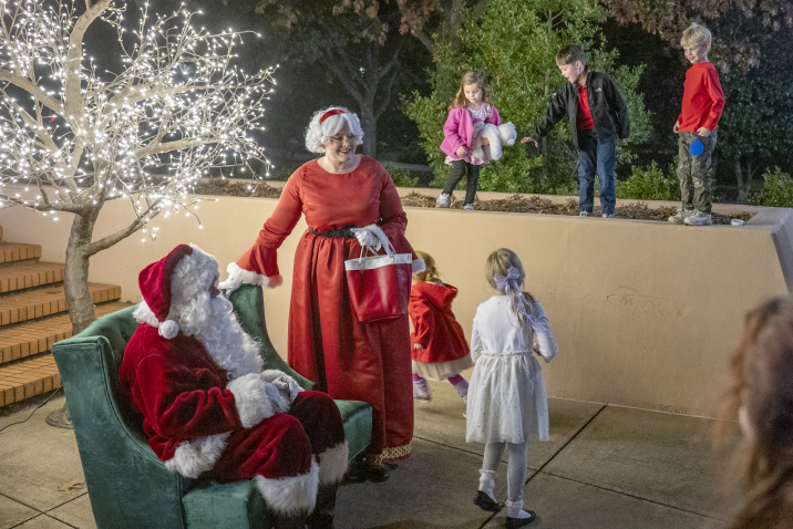 child approaching Mr. and Mrs. Claus
