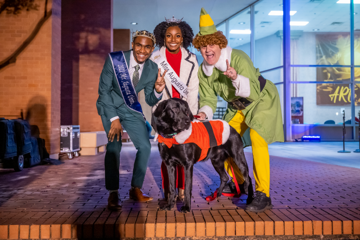 Mr. Augusta University, Miss Augusta University, and a man dressed as Buddy the Elf
