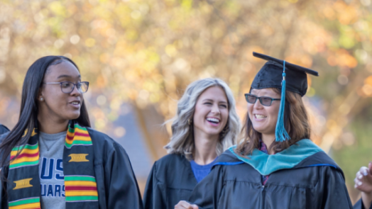 women walking in caps and gowns