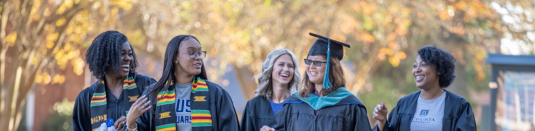 women walking in caps and gowns
