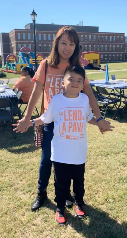 woman and her son holding hands