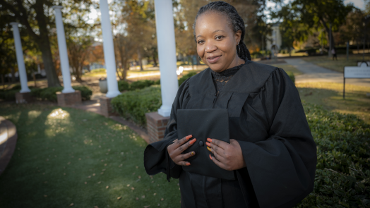 woman standing in cap and gown