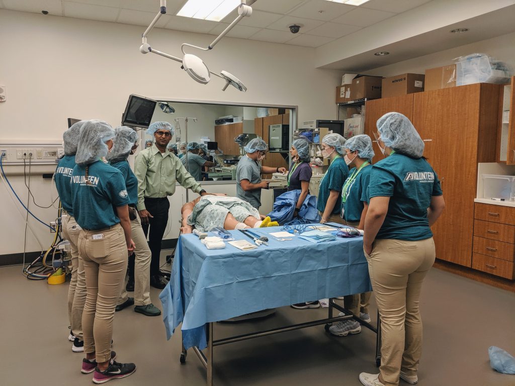 students standing in operating room simulation