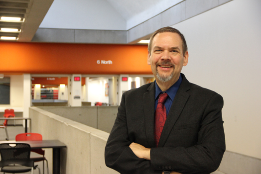 man in black suit smiling
