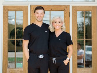 two dentists in black scrubs