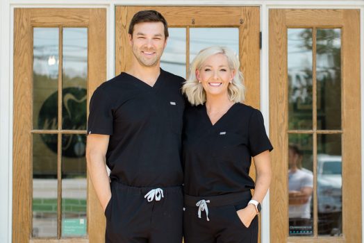 two dentists in black scrubs