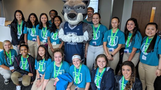 students standing with mascot