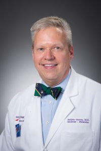 Man in white coat and bow tie