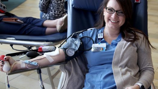 woman in scrubs giving blood