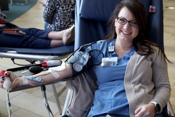woman in scrubs giving blood