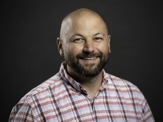 man in plaid shirt, smiling