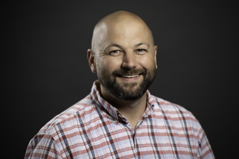 man in plaid shirt, smiling