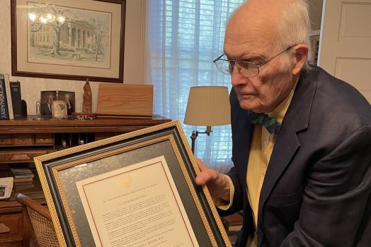 Man holds framed document