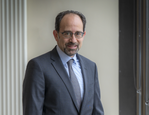 man in blue suit and glasses