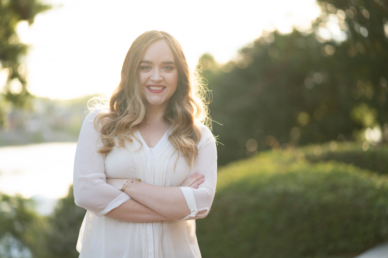 woman in white shirt standing outside