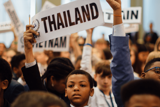 young students holding signs