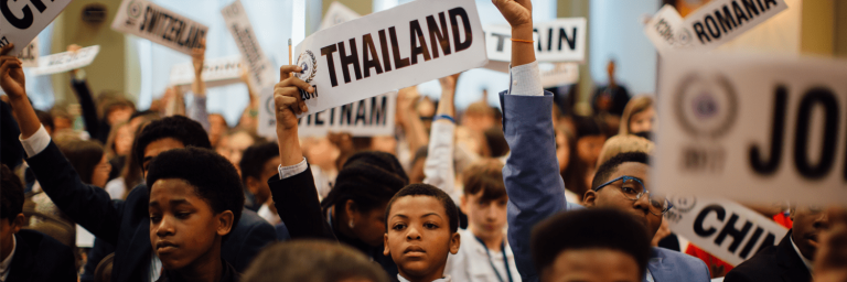 young students holding signs