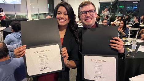two people holding certificates