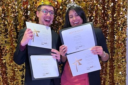 two people holding awards