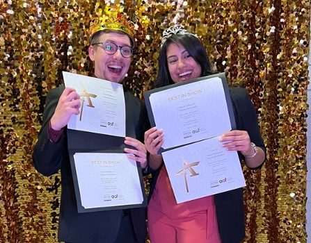 two people holding awards