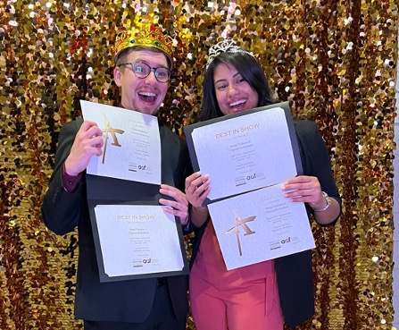 two people holding awards