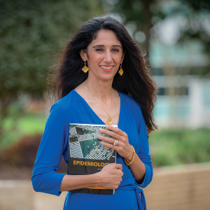 woman holding book outside