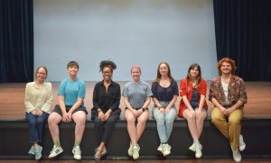 group of people sitting on a stage