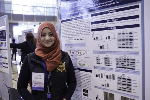 woman standing in front of a poster