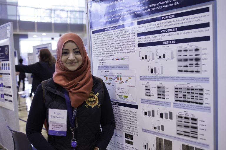 woman standing in front of a poster