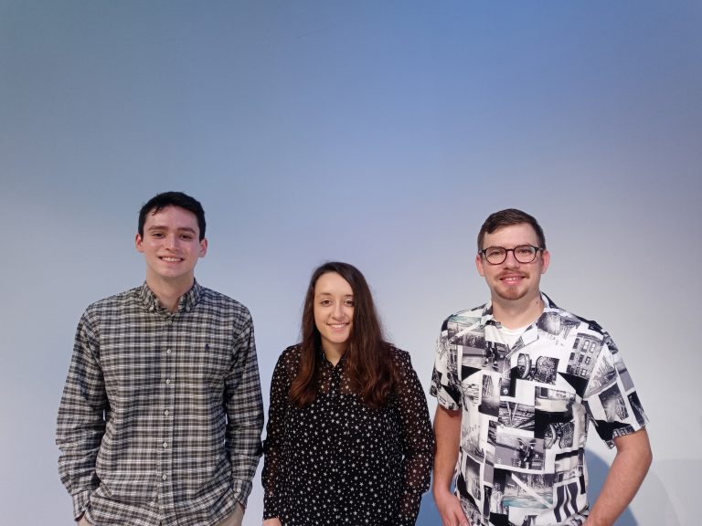 three people against a grey background