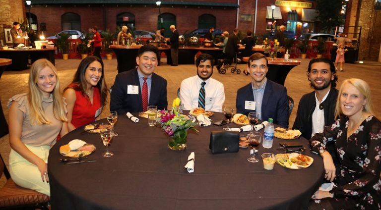 7 people seated at dinner table