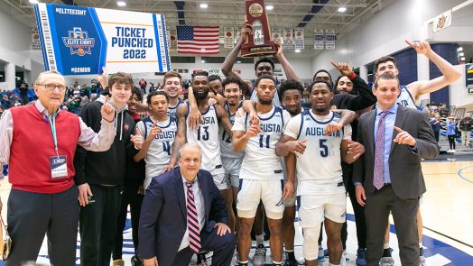 Men posing with trophy