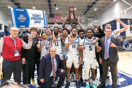 Men posing with trophy