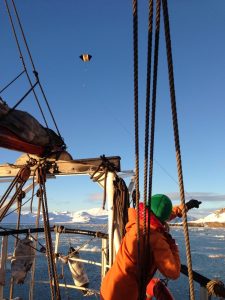 Woman on a boat flying a kite