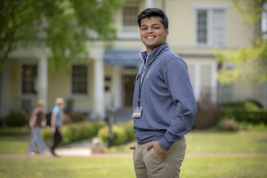 man in blue shirt standing outside