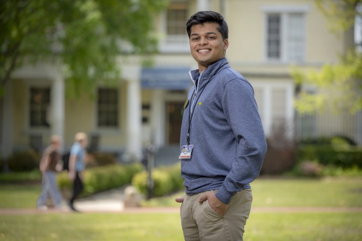 man in blue shirt standing outside