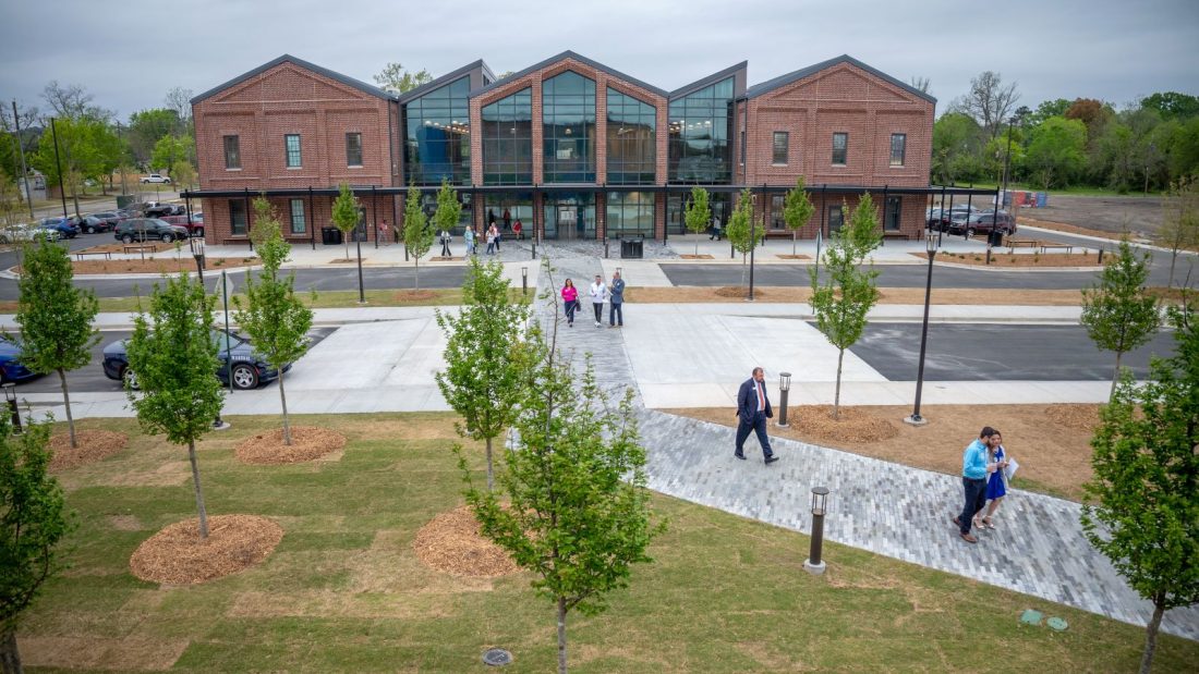 People outside a new building
