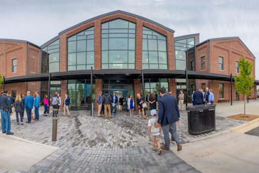 people outside a new building